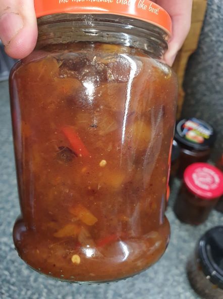 Image of a jar containing mango chutney.